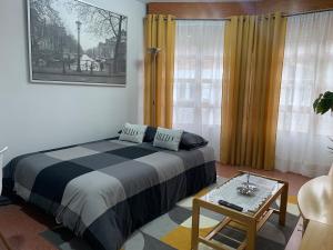 a bedroom with a bed and a table in a room at La casita de Lukas in Sabero