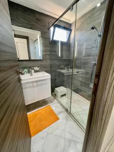 非斯prestigia fes luxury appartement的浴室里有淋浴、洗手池和镜子。 更多17张照片