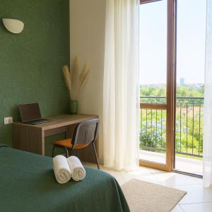a bedroom with a bed and a desk and a window at Residenze Italia in Sesto San Giovanni