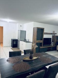 a dining room table with chairs and a kitchen at Cocon family in Strasbourg