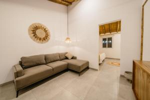 a living room with a brown couch in a room at Vikara in Olón