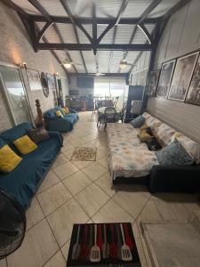 a living room with couches and a room with at residence caramboles in Fort-de-France