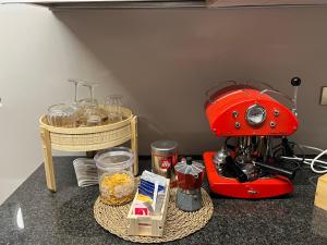 a red mixer sitting on a counter with food at A Casa di Cheope in Bettolelle