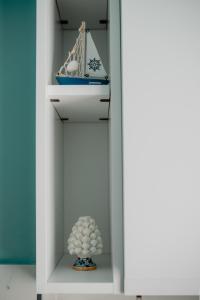 a shelf with a model of a ship and a vase at Sarina's apartment in Palermo