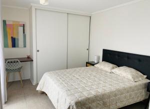 En eller flere senge i et værelse på Depto Parque Parinacota a pasos de la playa + 6 billeder