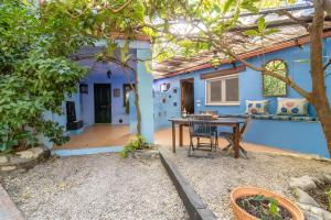 a patio with a table and chairs in front of a house at Aguas Calmas in Nigüelas