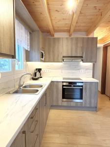 a kitchen with a sink and a stove at Theo Two-Bedroom Apartment in Marathias