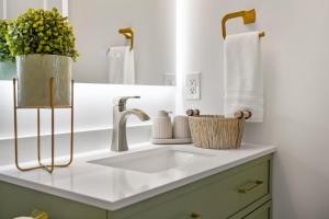 a bathroom counter with a sink and a mirror at The Copperleaf Luxury Retreat with Hot tub in Calgary +39 photos