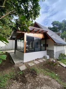 a house with a large window on the side of it at Cabaña de Montaña Flaki's in Monteverde Costa Rica