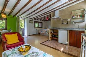 a kitchen and living room with a couch and a table at Aguas Calmas in Nigüelas
