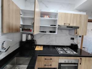 a kitchen with a sink and a stove top oven at Brand new apartment in Sport city Tangier in Tangier