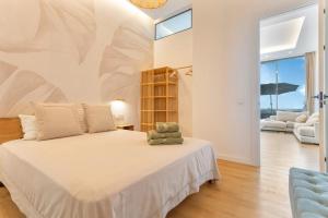 a bedroom with a large bed and a couch at MAAR Suites Cotillo in El Cotillo