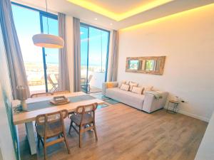 a living room with a table and chairs and a couch at MAAR Suites Cotillo in El Cotillo