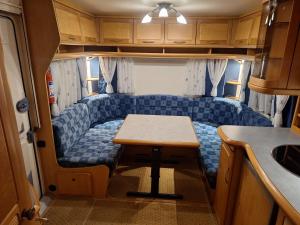 a living room with a table in an rv at Proboost Arctic Center Cosy Caravan in Rovaniemi +41 photos