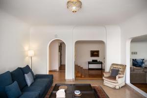 a living room with a blue couch and a table at The White Coconut Stay in Cairo
