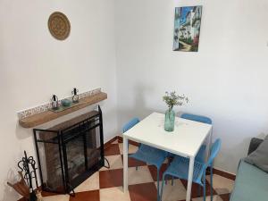 a living room with a table and a fireplace at Zahara Lovers in Zahara de la Sierra +9 photos