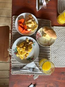 una mesa con tazones de comida y un tazón de fruta en Glamping Entre Mangos, en La Mesa