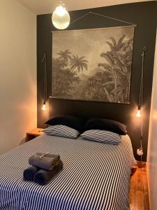 a bedroom with a bed with a large painting on the wall at Maison de pêcheur proche du bourg in Ile aux Moines