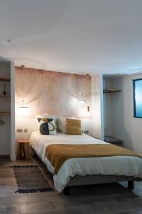 ein Schlafzimmer mit einem großen Bett in einem Zimmer in der Unterkunft Les Terrasses de MAJORAC - La Grange in Bozouls