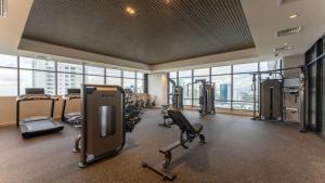 a gym with treadmills and exercise equipment in a building at Executive Rental Studio w Skyline Views in Panama in Panama City +15 photos
