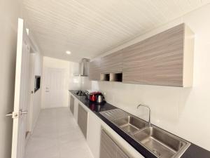 a kitchen with a sink and a counter top at Tropical home close to nature and city in Ban Mai I +6 photos