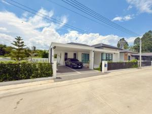 a house with a car parked in the driveway at Tropical home close to nature and city in Ban Mai I