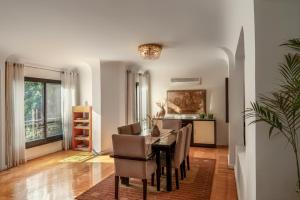 a dining room with a table and chairs at The White Coconut Stay in Cairo