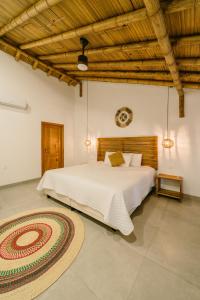 a bedroom with a large bed and a rug at Vikara in Olón