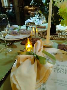 a table with a table cloth with a candle on it at CABIN C at Bigang Munti Beach Resort in Bootin