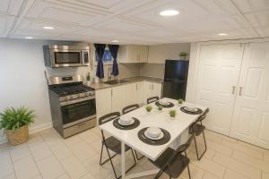 a kitchen with a table and chairs in it at Nice 3BR Apt | 3 Beds |15 Min to NYC/Manhattan! in North Bergen