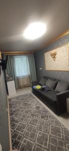 a small bedroom with a bed and a rug at Центр 2окремі кімнати балкон in Ivano-Frankivsʼk