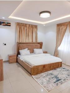 a bedroom with a large bed and a window at Epic Apartment in Abuja +12 photos