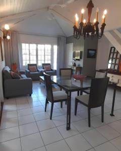 uma sala de estar com mesa e cadeiras em Linda casa para temporada no Peró/Cabo Frio em Cabo Frio