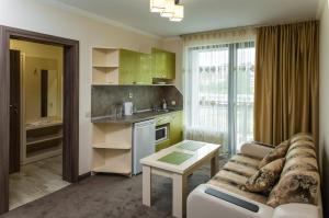 a kitchen and living room with a couch and a table at Emmar Zlatograd in Zlatograd
