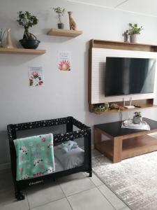 a living room with a tv and a table at Luna Luxury Living in Nelspruit