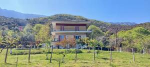 a house in the middle of a field with trees at Country Home Genesi 20 min from Trikala in Genésion