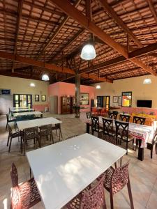 a large room with tables and chairs in a building at Espaço Krisalys in Guararema +25 photos