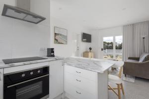 a white kitchen with a stove and a counter top at Peaceful 2-Bed Apartment in Coastal McCrae in McCrae