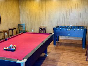 a room with a pool table and two chairs at Emerald Arrowhead Haus - For 6 in Lake Arrowhead