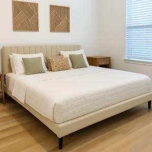 Cette chambre blanche comprend un grand lit blanc et des oreillers. dans l'établissement Cozy & Chic - Worker Friendly, à Sherman