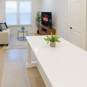 a living room with a white counter and a tv at Cozy apartment by Pecan Park Texoma Med & More in Sherman +17 photos