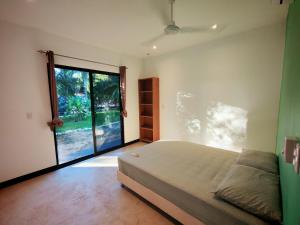 a bedroom with a bed and a large window at Pyramid Rocca in Tamarindo +96 photos