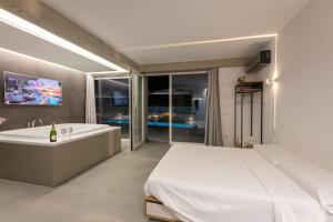 a bedroom with a large bed and a bath tub at Tropicana Suite - Adults Only in Agropoli