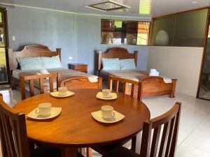 a room with a table and chairs and a bedroom at Little Paradise in Nuevo Arenal +40 photos