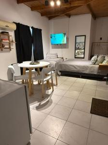 a living room with a bed and a table and chairs at Merlo ink3 in Merlo +15 photos