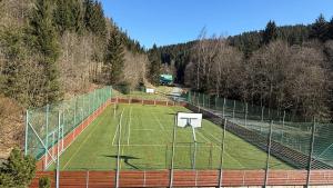a tennis court with a net on top of it at Wellness Hotel Zdobnice in Zdobnice