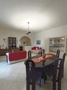 a living room with a table and a couch at AleMar House in Marinella di Selinunte