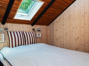 a bedroom with a bed with a window at Secluded Haven near Sea - By Traum Ferienwohnungen in Øster Vrøgum +12 photos