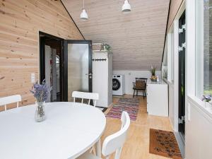 a dining room with a white table and chairs at Secluded Haven near Sea - By Traum Ferienwohnungen in Øster Vrøgum