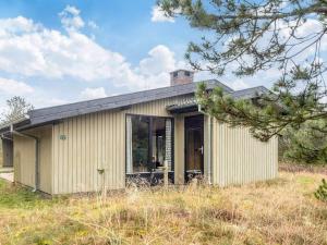 a small house with glass doors on a field at Luxury Retreat in Blavand - By Traum Ferienwohnungen in Blåvand